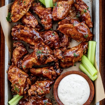 Overhead of BBQ Chicken Wings with Ranch and Celery.