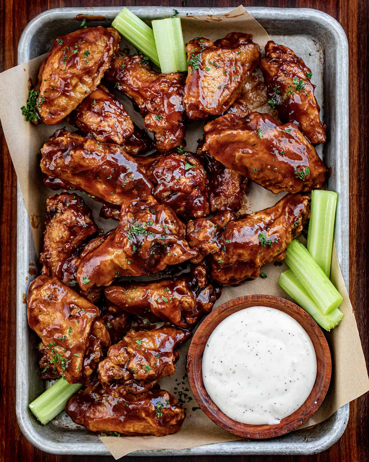Overhead of BBQ Chicken Wings with Ranch and Celery.