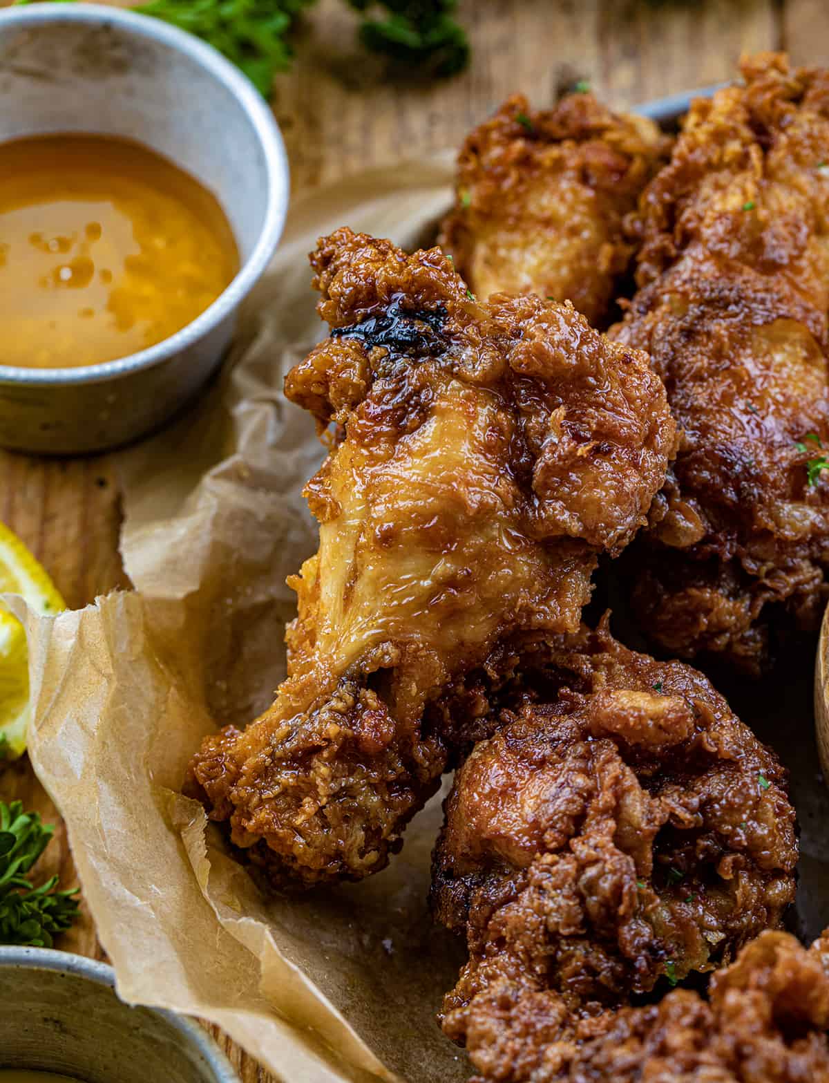 Close up of Buffalo Honey Mustard Chicken Wing Next to Honey.