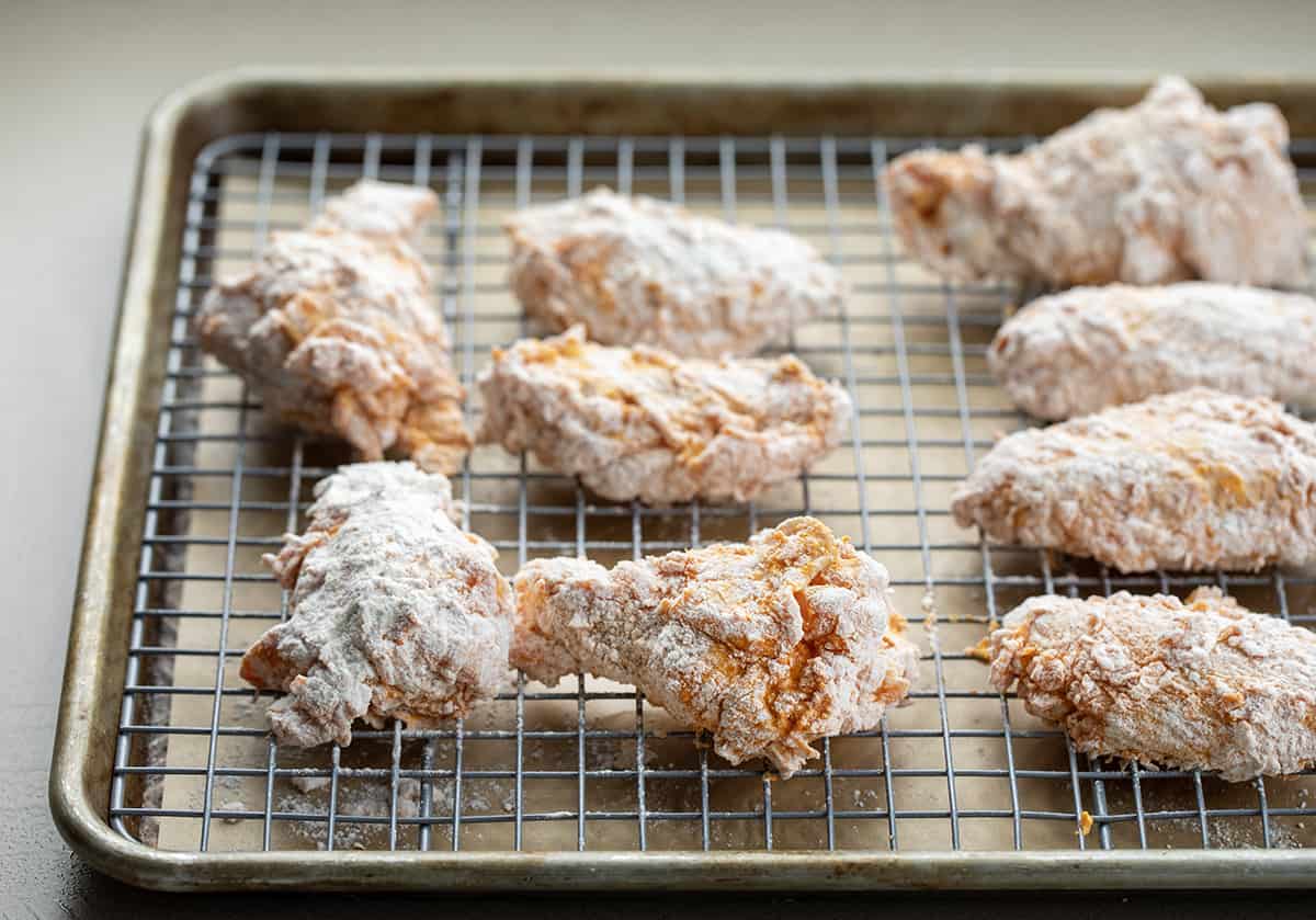 Raw Wings After Being Coated in Buffalo Sauce and then Rolled in Flour.