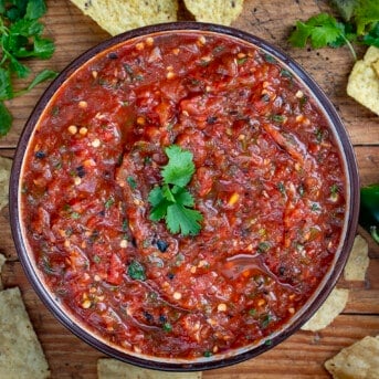 Bowl of Roasted Salsa with Chips on Cutting Board.