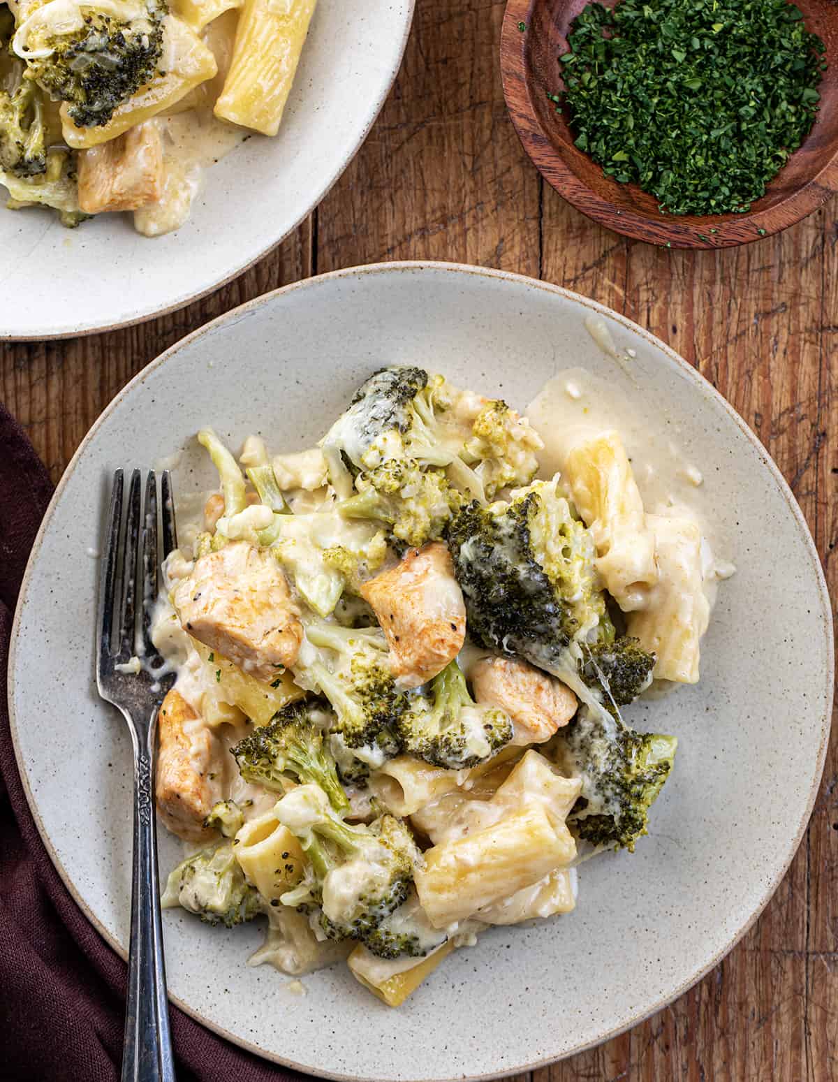Chicken and Broccoli Pasta on a Plate on a Wooden Cutting Board.