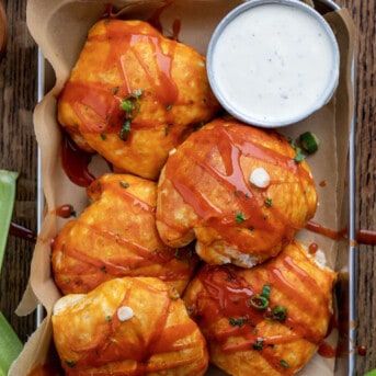 Buffalo Chicken Bombs in a Pan with Ranch Dressing and Celery from Overhead.