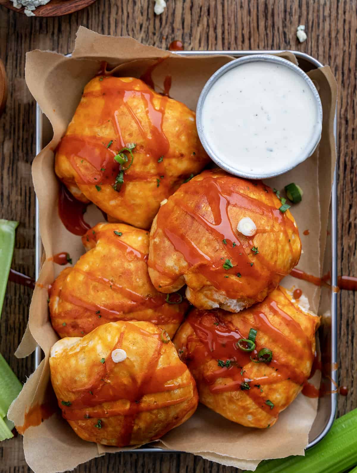 Buffalo Chicken Bombs in a Pan with Ranch Dressing and Celery from Overhead.