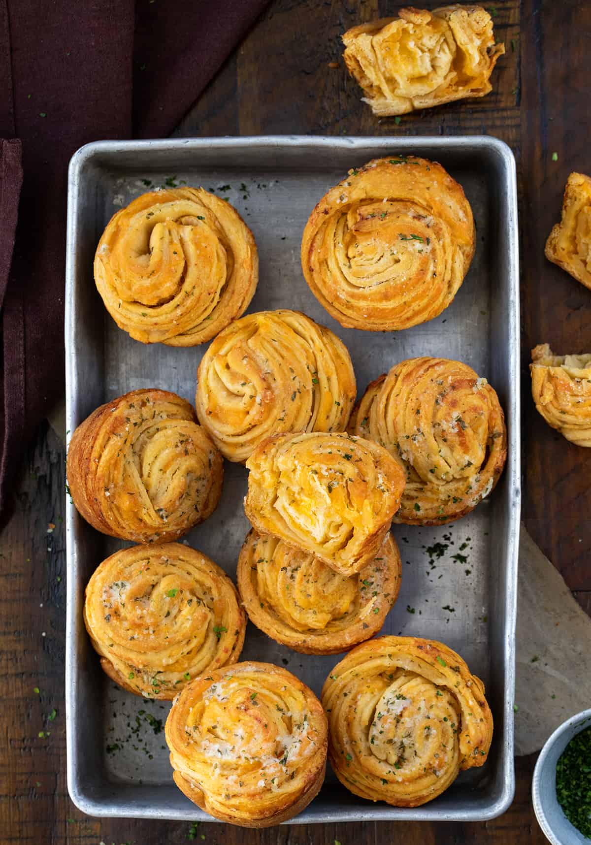 Pan of Easy Cheesy Cruffins with Some Cut in Half to Show Inside.