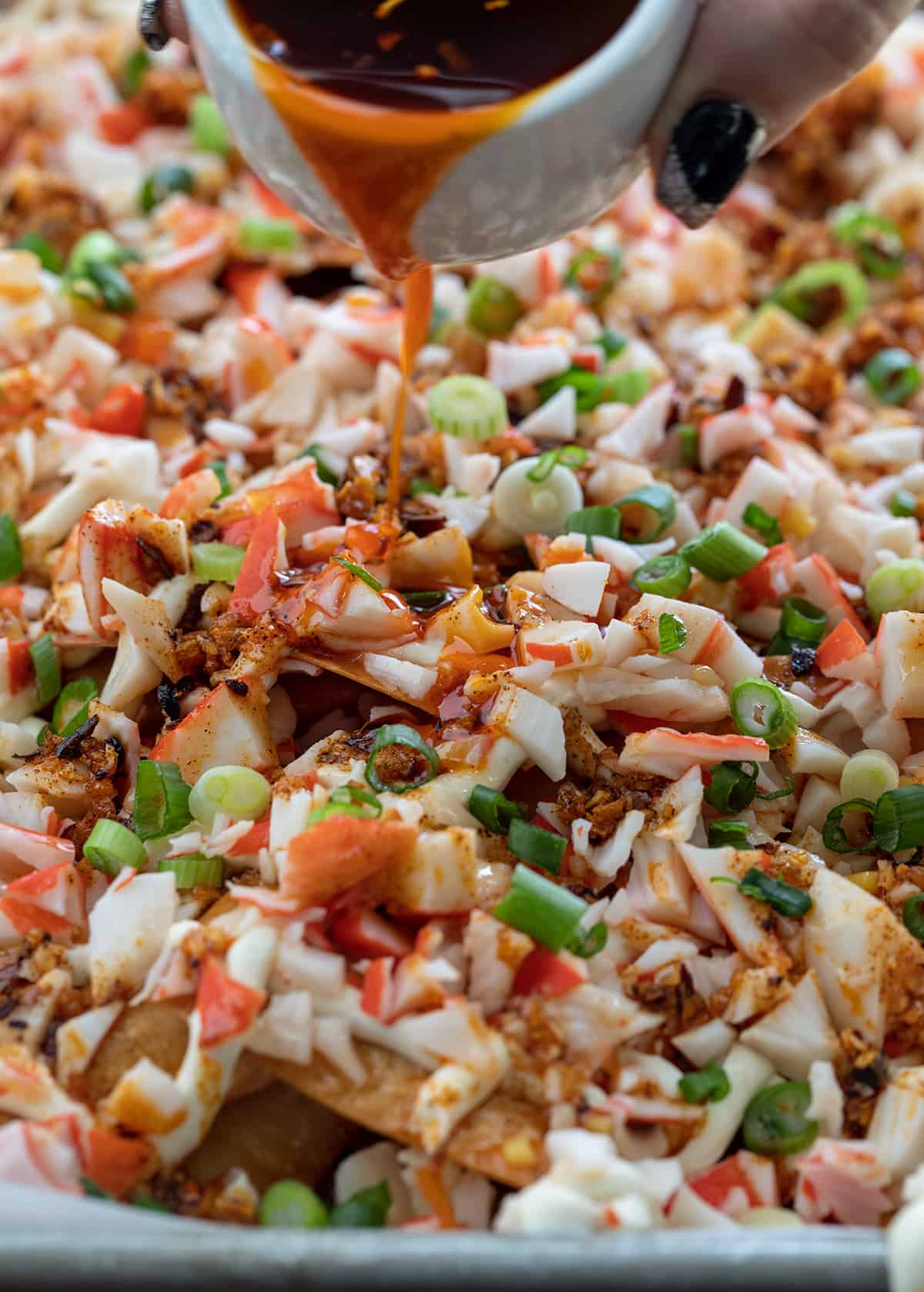 Close up of Crab Rangoon Nachos with Chili Sauce.