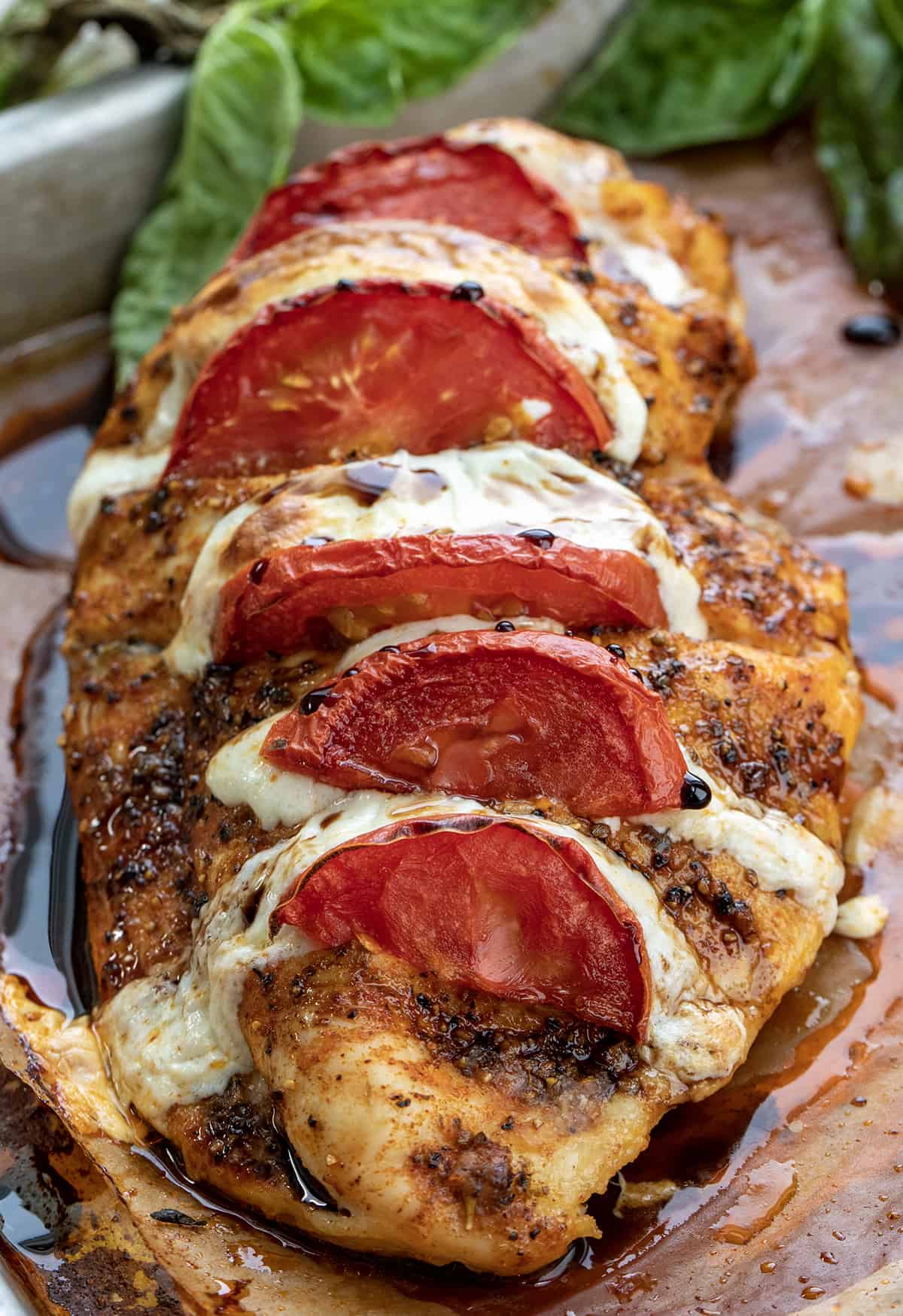 One piece of Caprese Hasselback Chicken on Baking Sheet.