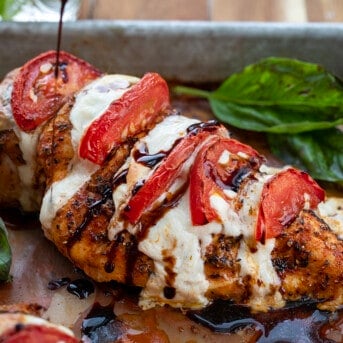 Pouring a Balsamic Glaze Reduction Over Caprese Hasselback Chicken.