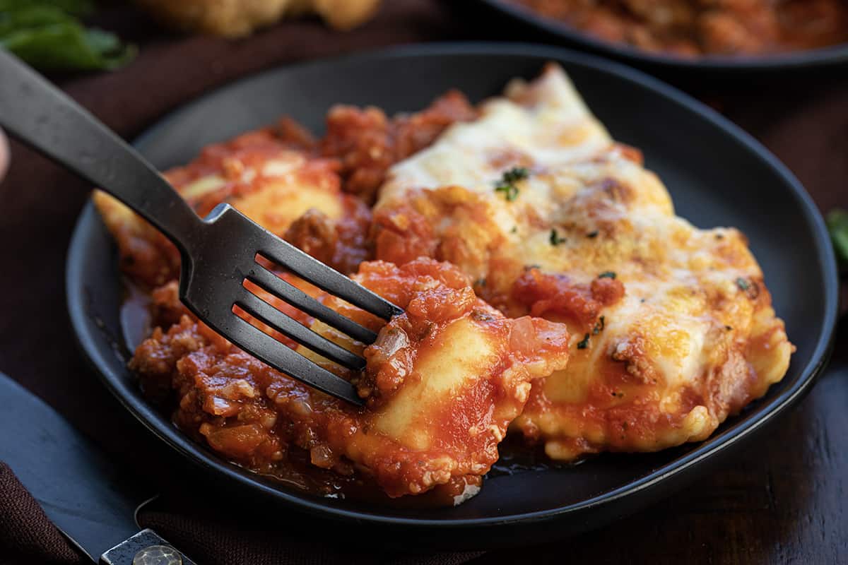 Fork Taking a Piece of Ravioli from a Plate.