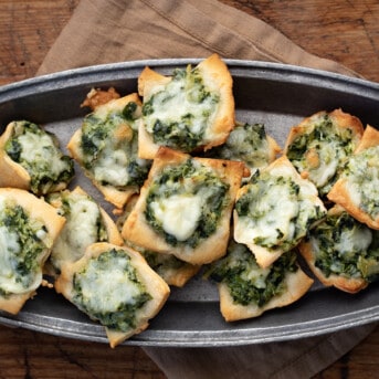 Pan of a Bunch of Spinach Dip Bites on a Cutting Board.