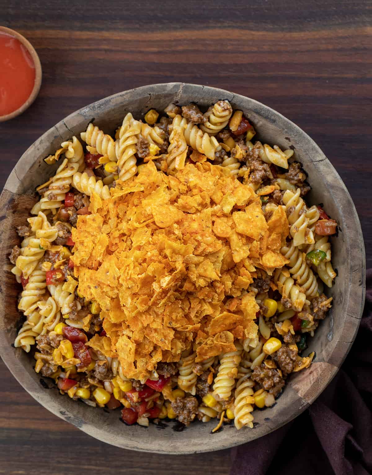 Wooden Bowl of Taco Pasta Salad Before Mixing in the Chips.