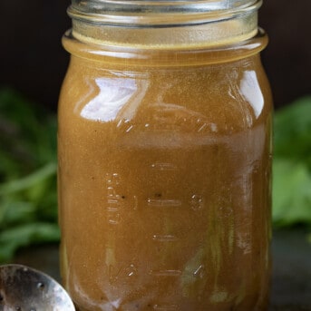 Jar of Creamy Balsamic Vinaigrette with a Spoon Next to It.