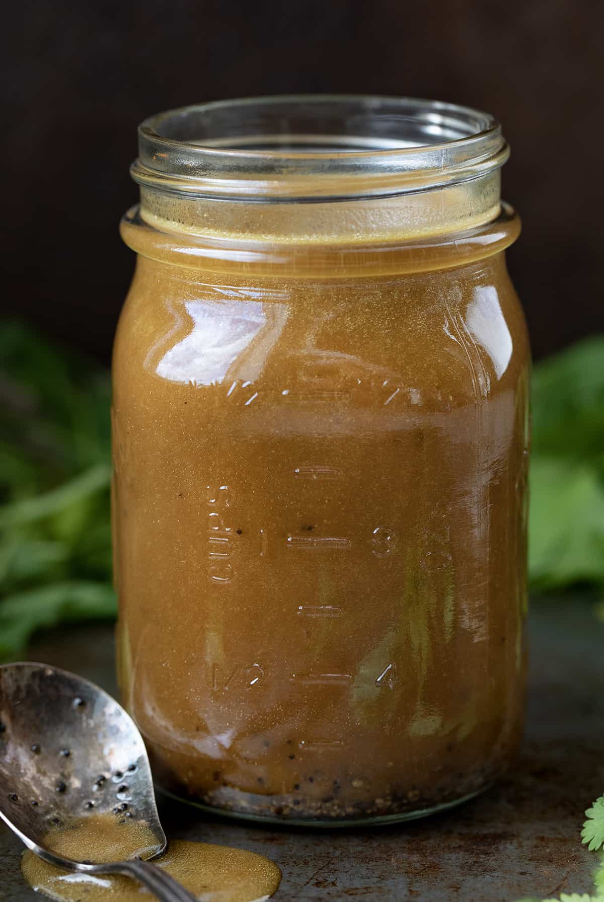 Jar of Creamy Balsamic Vinaigrette with a Spoon Next to It.