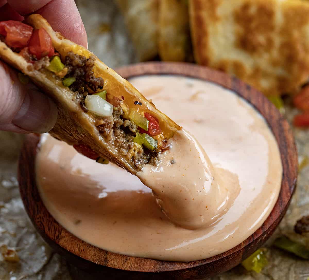 Dipping Cheeseburger Quesadilla Into Fry Sauce.