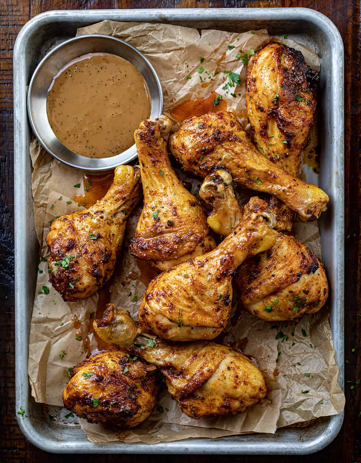 Chicken Legs on a Pan with Sauce on a Cutting Board. 
