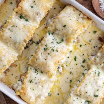 Close up of French Onion Lasagna Roll-Ups in a Casserole Dish.