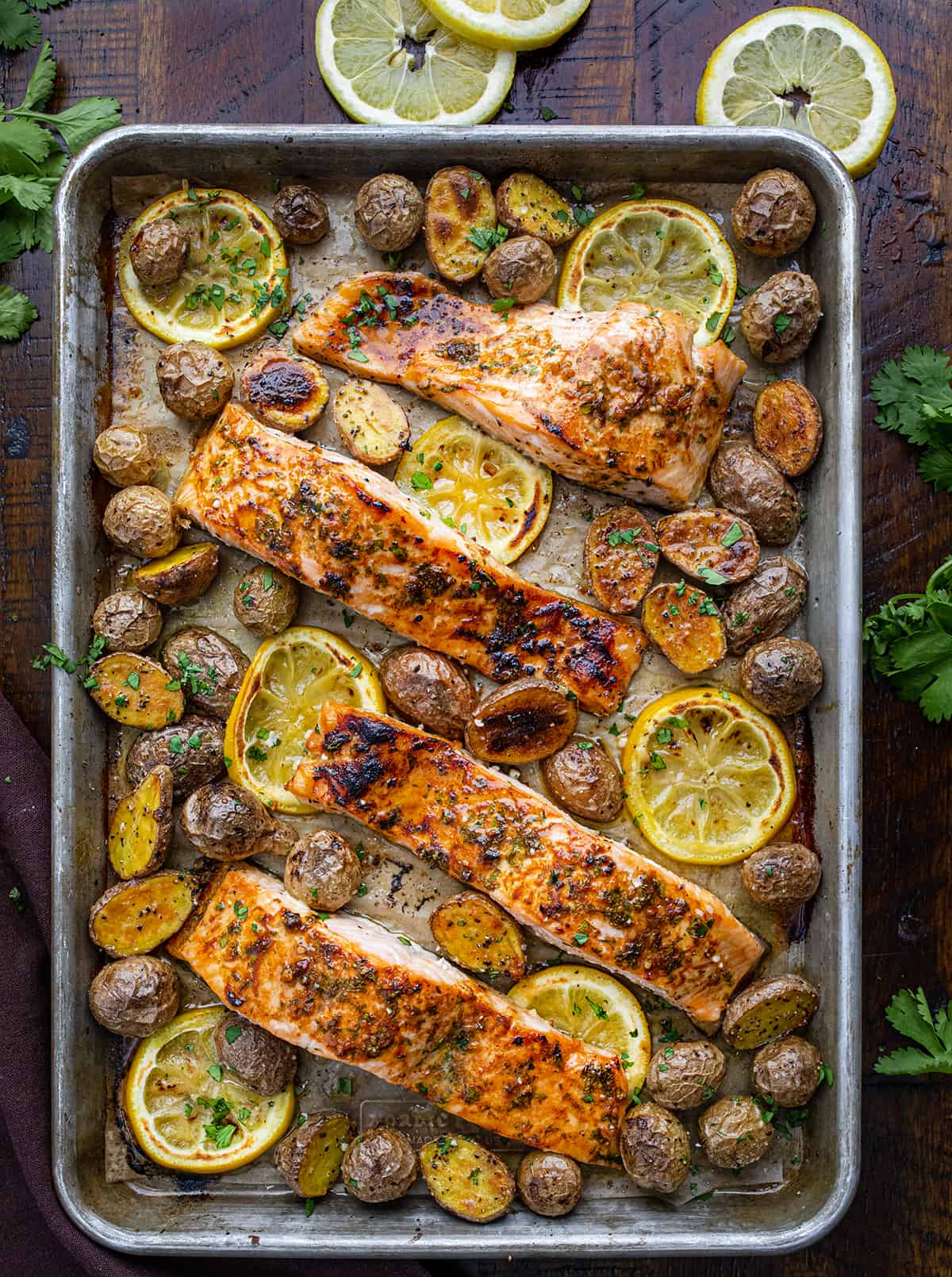 Sheet Pan Lemon Salmon and Potatoes After Cooking on a dark Cutting Board. 