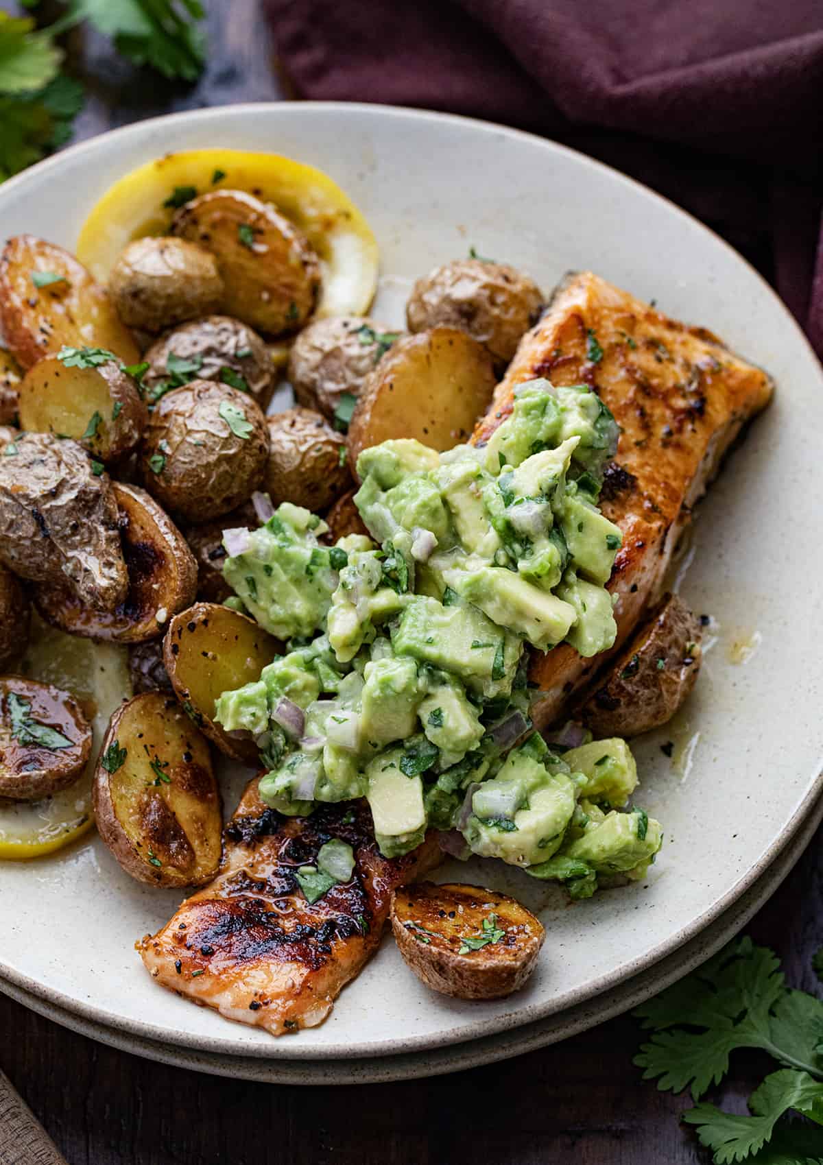 Plated Sheet Pan Lemon Salmon and Potatoes with the Fresh Avocado Salsa.