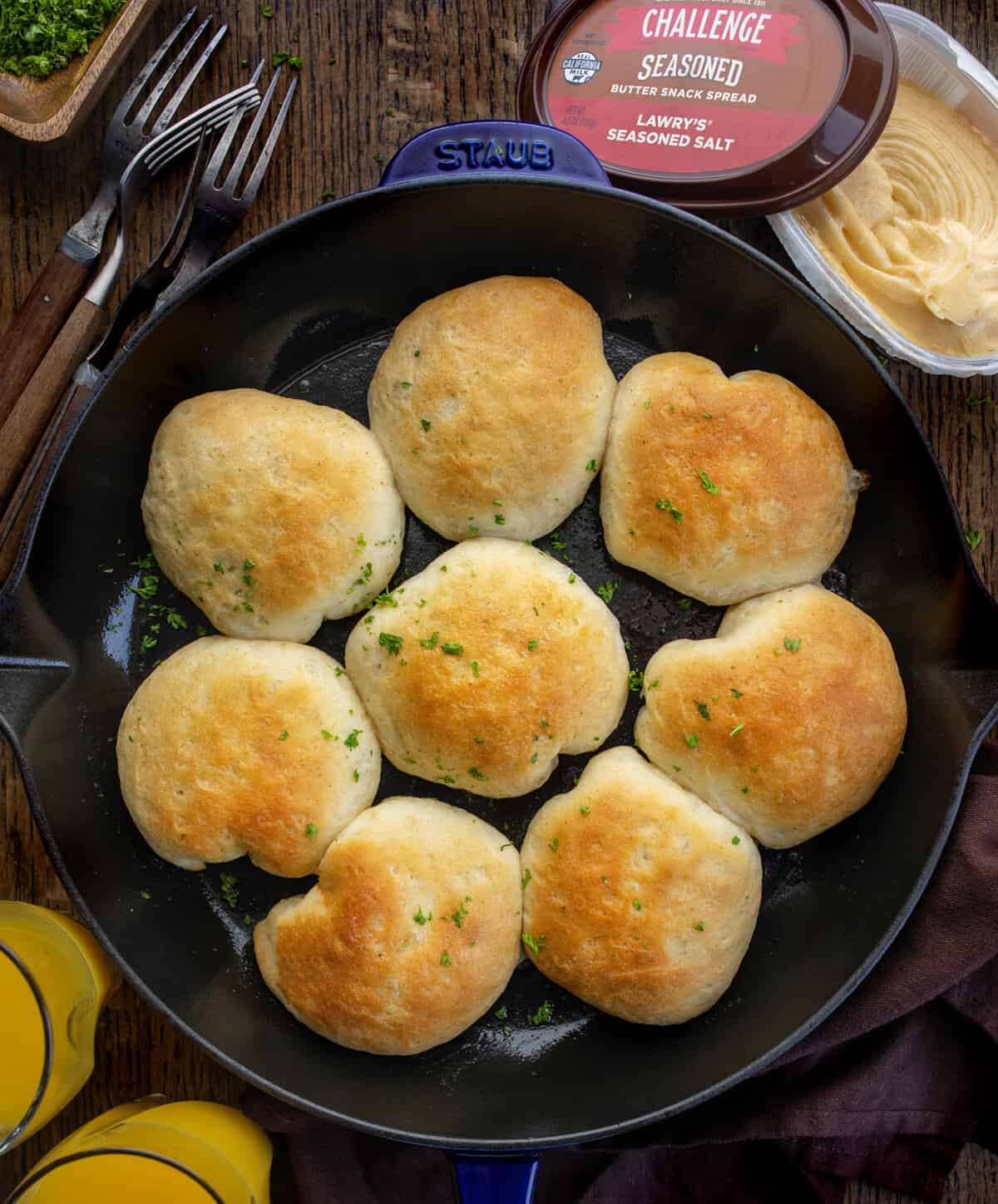 Skillet with Seasoned Biscuits and Gravy Bombs on a Dark Table. 