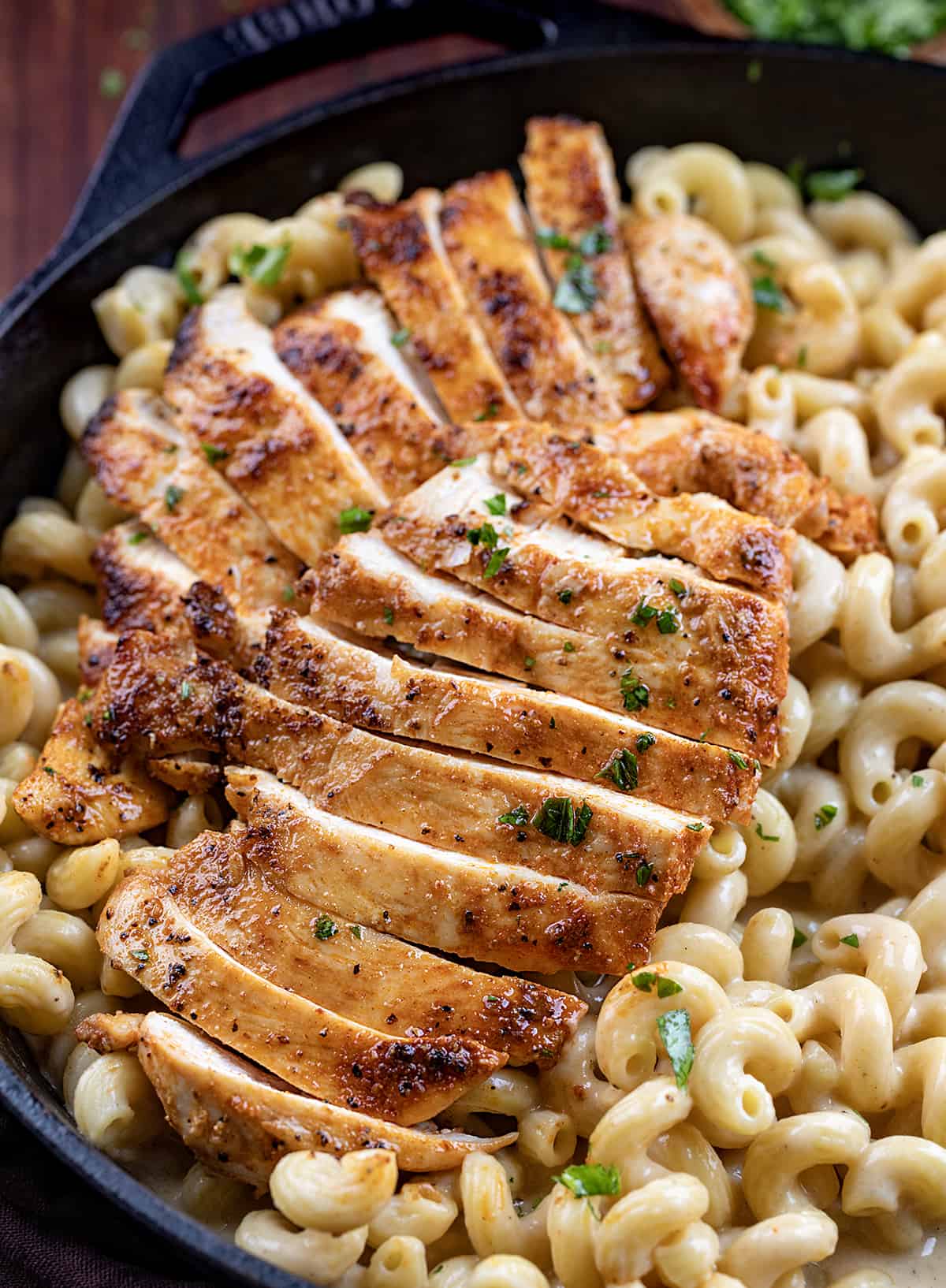 Cut into Chicken on Top of White Cheddar Chicken Pasta Noodles.