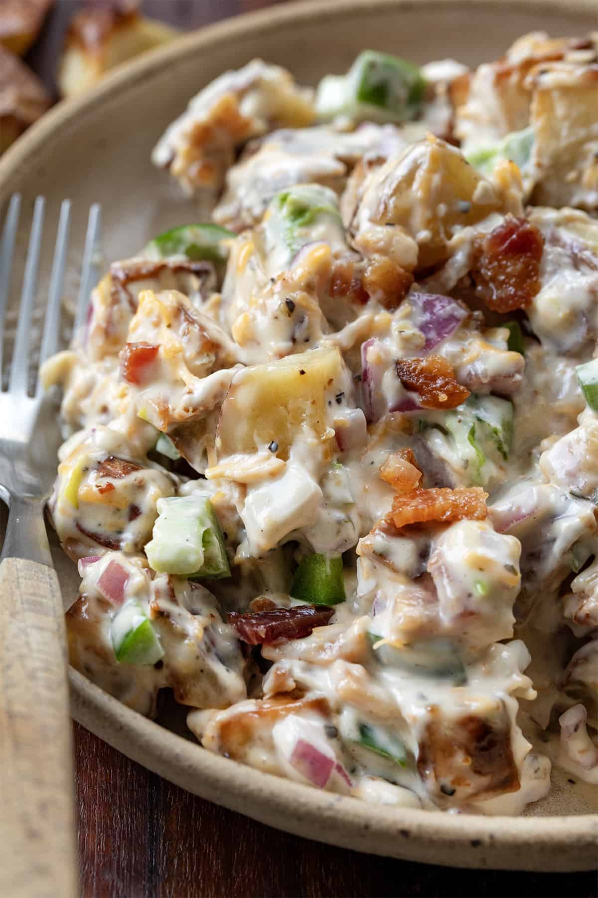 Close up of Jalapeño Popper Roasted Potato Salad on Plate Next to Fork.