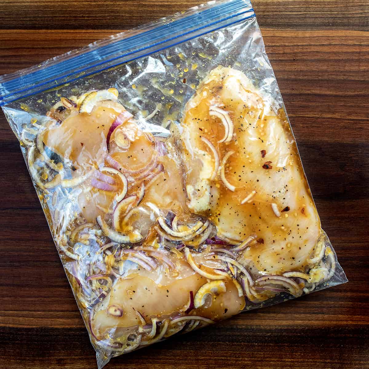 Bag of Raw Roasted Peach Chicken Marinating Before Roasting.