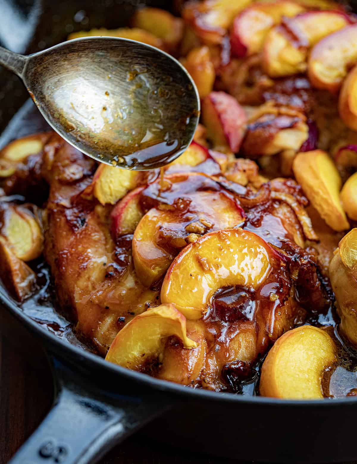 Spooning Glazed Over Roasted Peach Chicken in the Skillet.