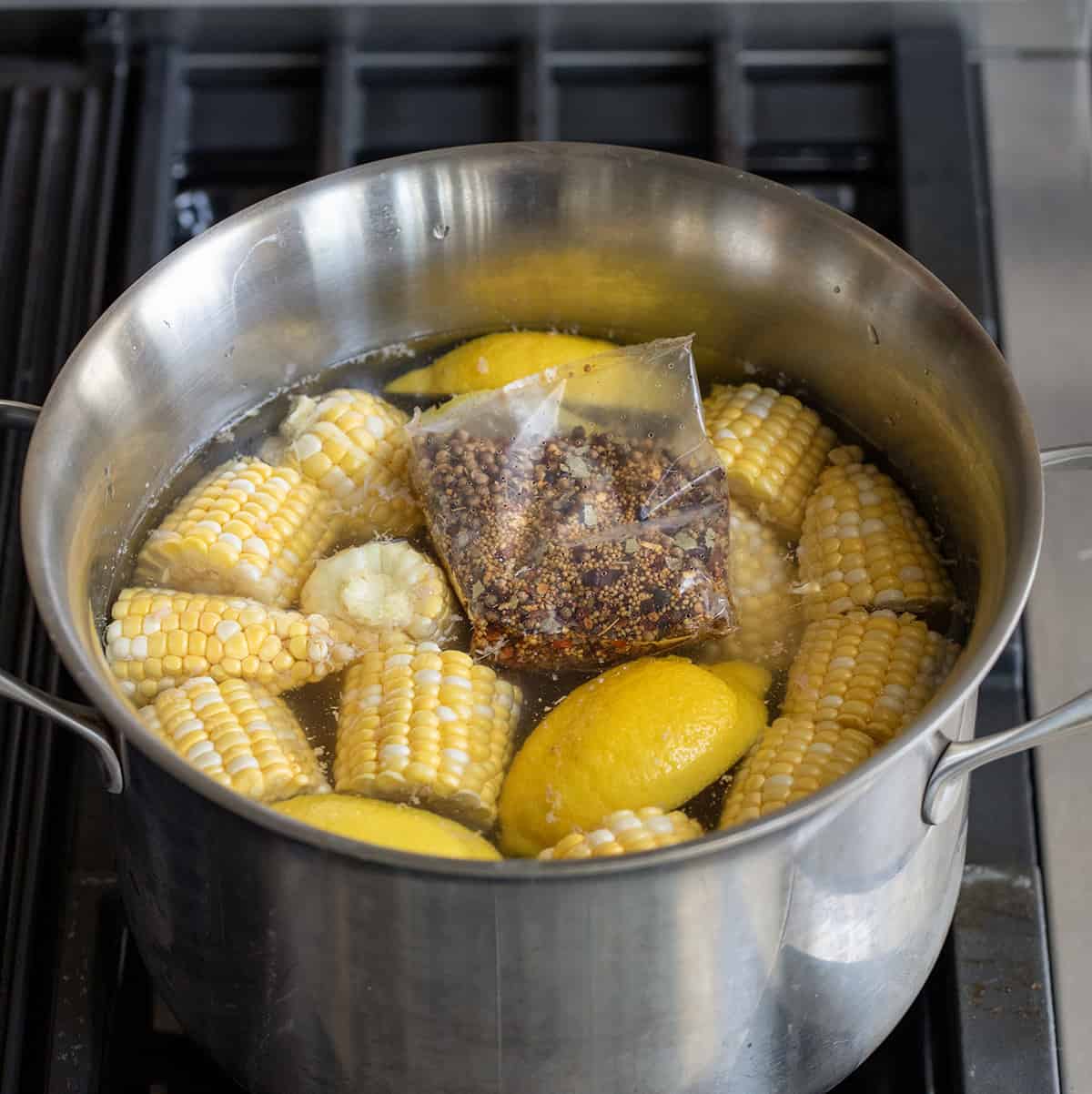 Pot with Lemon, Corn, and Sausage, and Flavor Packet for Easy Shrimp Boil.