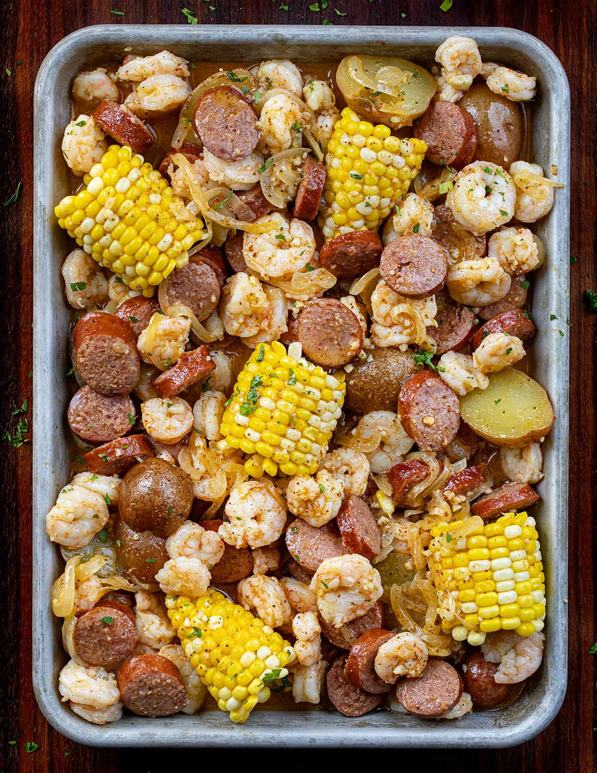 Easy Shrimp Boil in a Pan on a Dark Cutting Board.