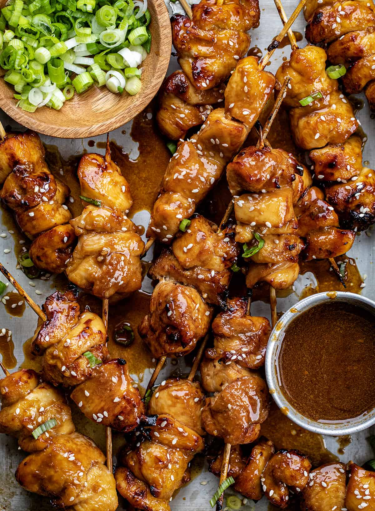 Teriyaki Chicken Skewers in a Pan with Teriyaki Sauce and Green Onions from Overhead.