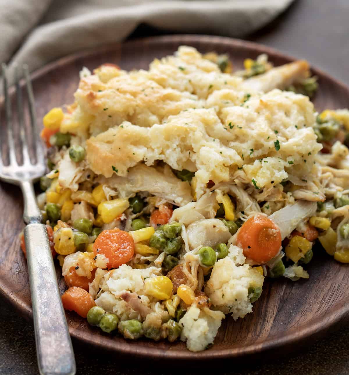 Wooden Plate with Butter Swim Biscuit Chicken Pot Pie on It.