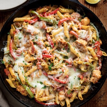 Skillet of Chicken Fajita Pasta from Overhead on a Wooden Table.