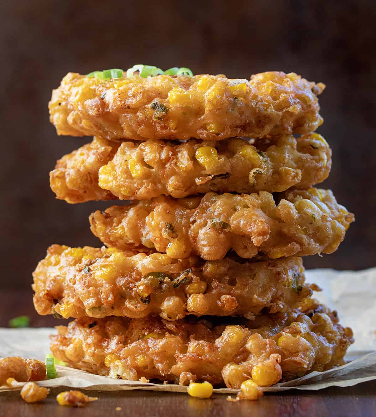 Stack of Corn Fritters on a Dark Counter.