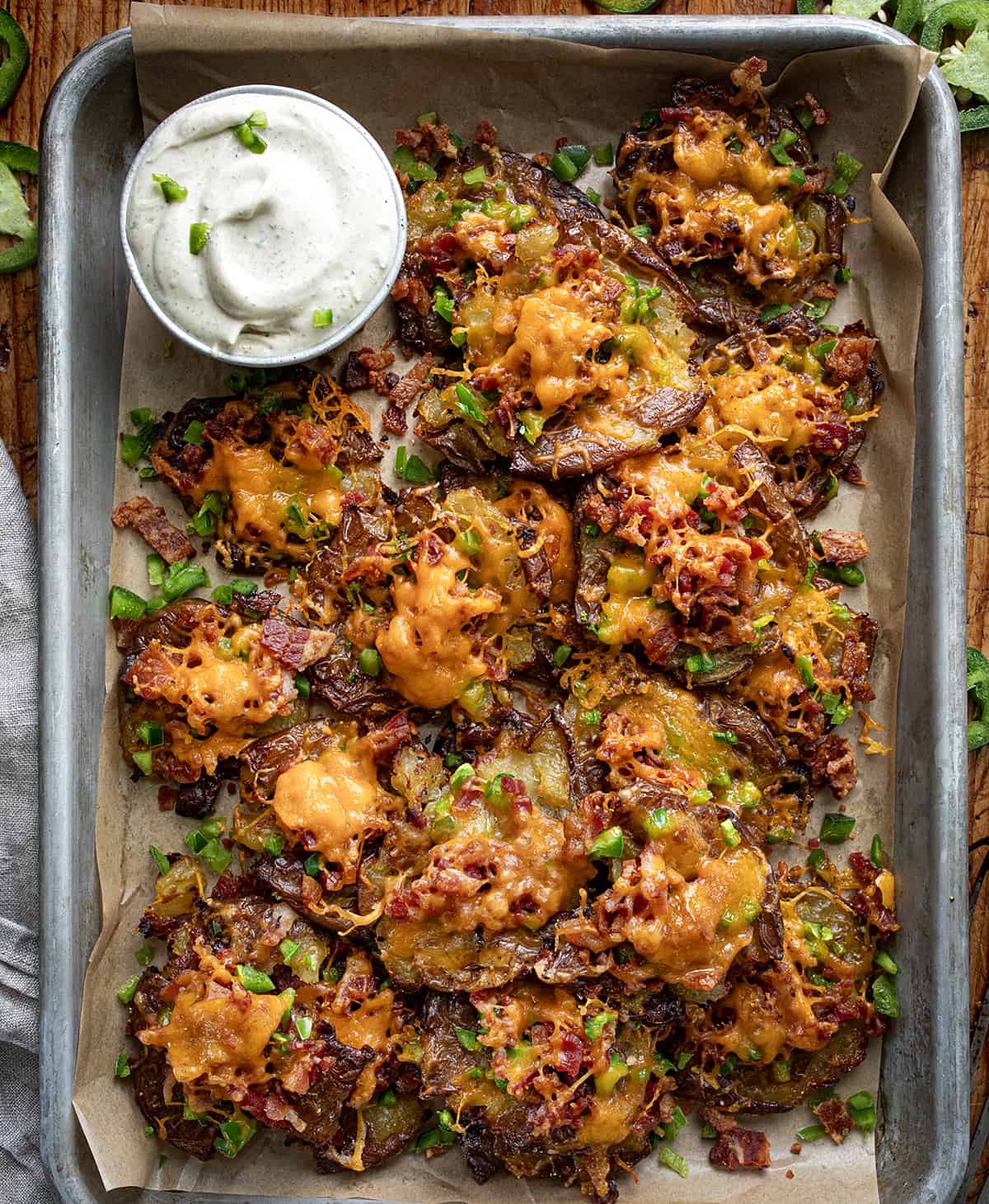 Tray of Jalapeno Popper Smashed Potatoes with Sauce from Overhead.
