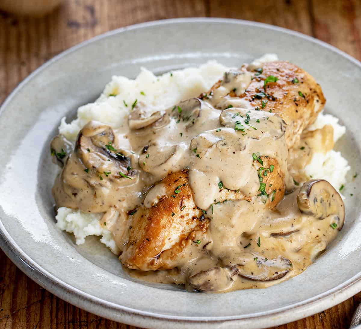 Plate of Chicken Breast Smothered in Mushroom Sauce over Mashed Potatoes.