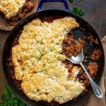 Skillet of Butter Swim Biscuit Sloppy Joe Bake with Some Removed Showing Texture Inside.