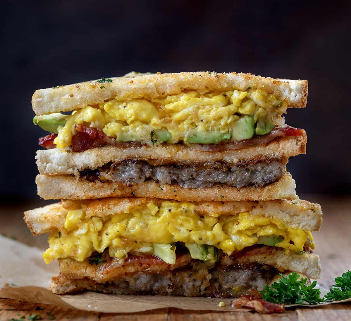 Stacked breakfast club sandwich on a wooden table. 
