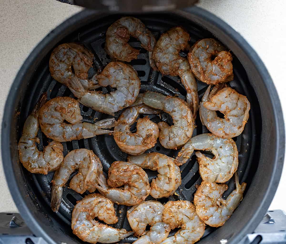 Raw Cajun Shrimp in Air Fryer Before Baking.
