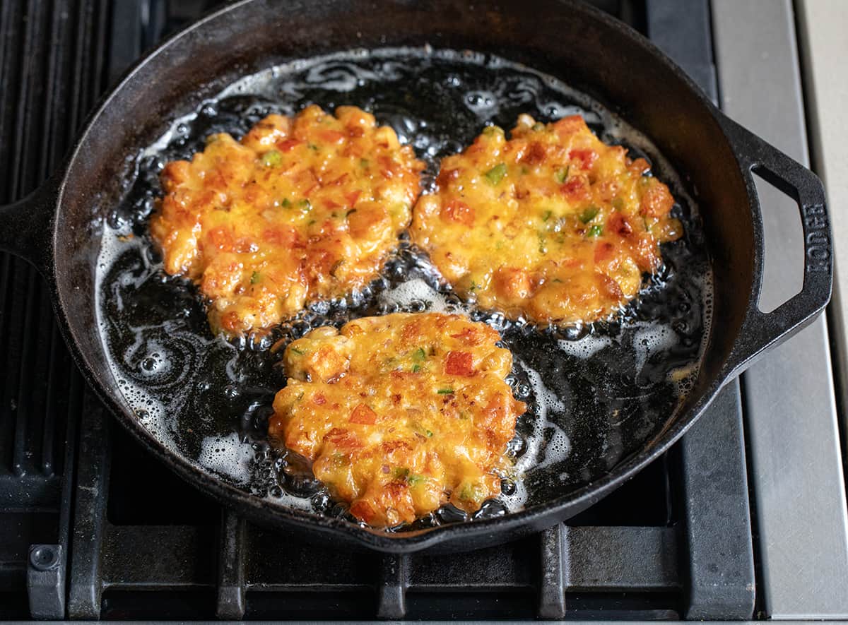Tomato Fritters Frying in a Skillet in Hot Oil.