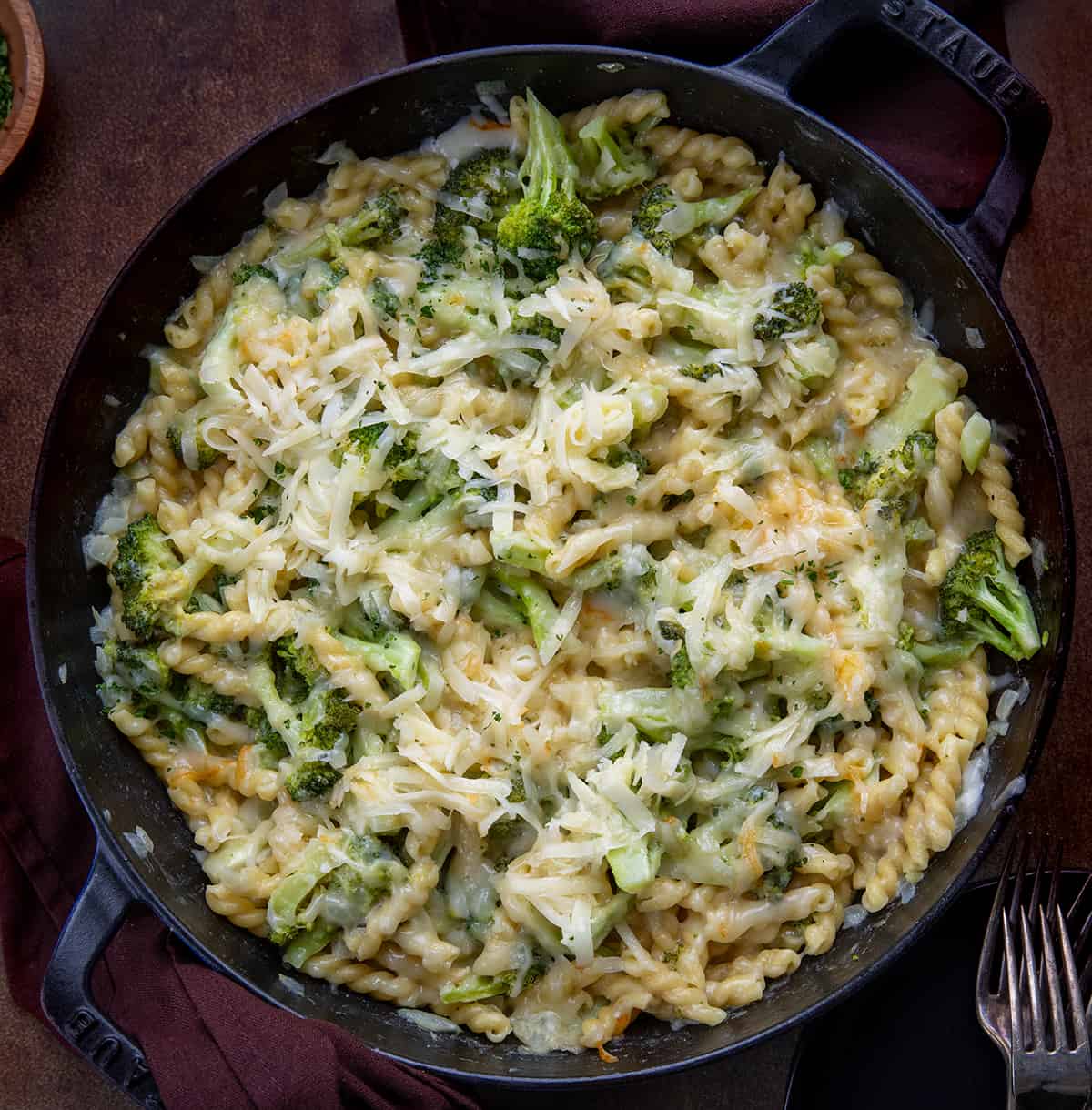 Broccoli Cheese Pasta in a Skillet on a Dark Table from Overhead.