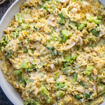 Closeup of Creamy Chicken and Broccoli Orzo in a skillet from overhead.