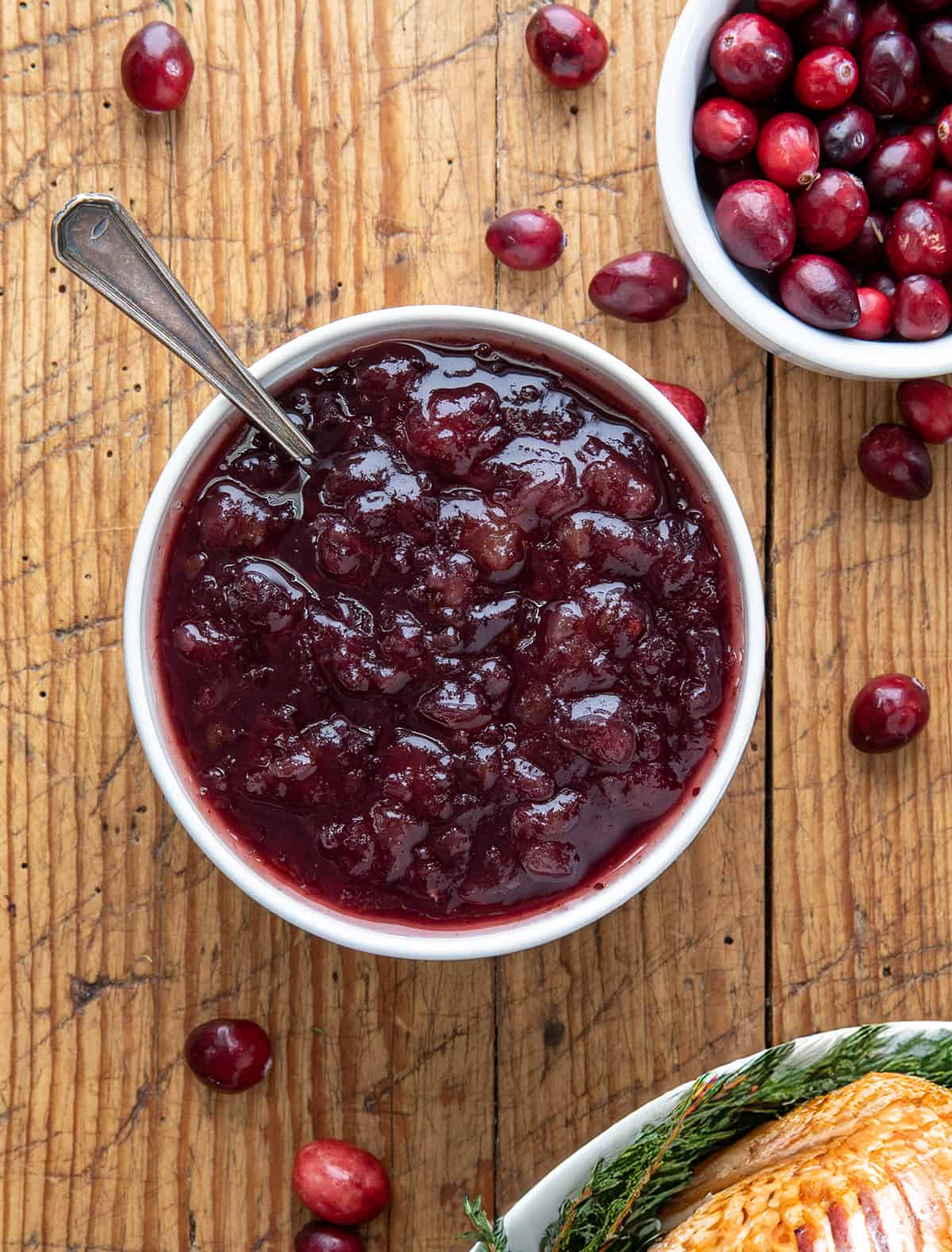 Looking down on a bowl of Easy Cranberry Sauce with a spoon in it.