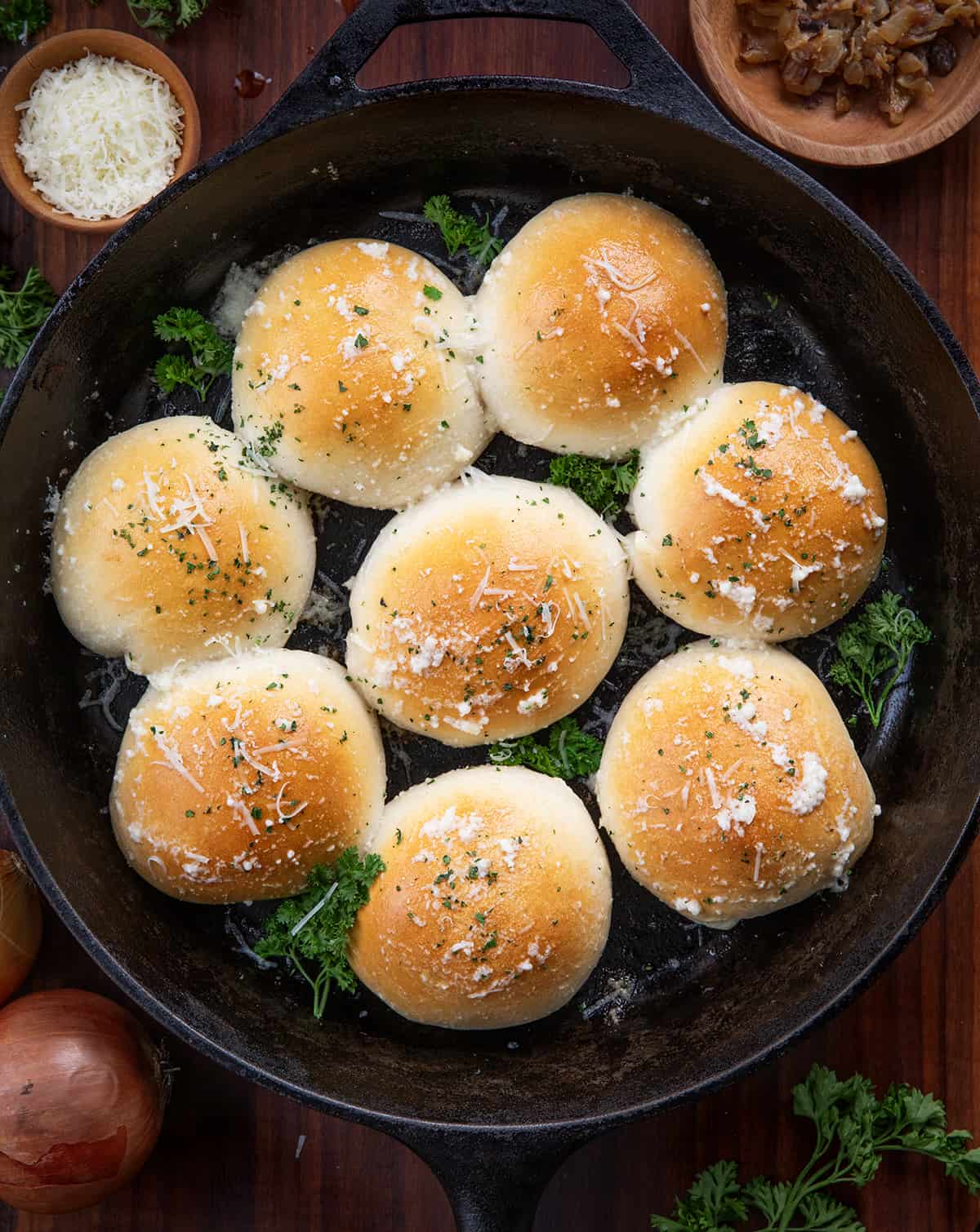 French Onion Bombs in a Skillet on a Dark Table from Overhead.