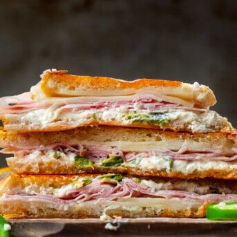 Stacked and halved Jalapeno Ham Grilled Cheese sandwiches on a counter.