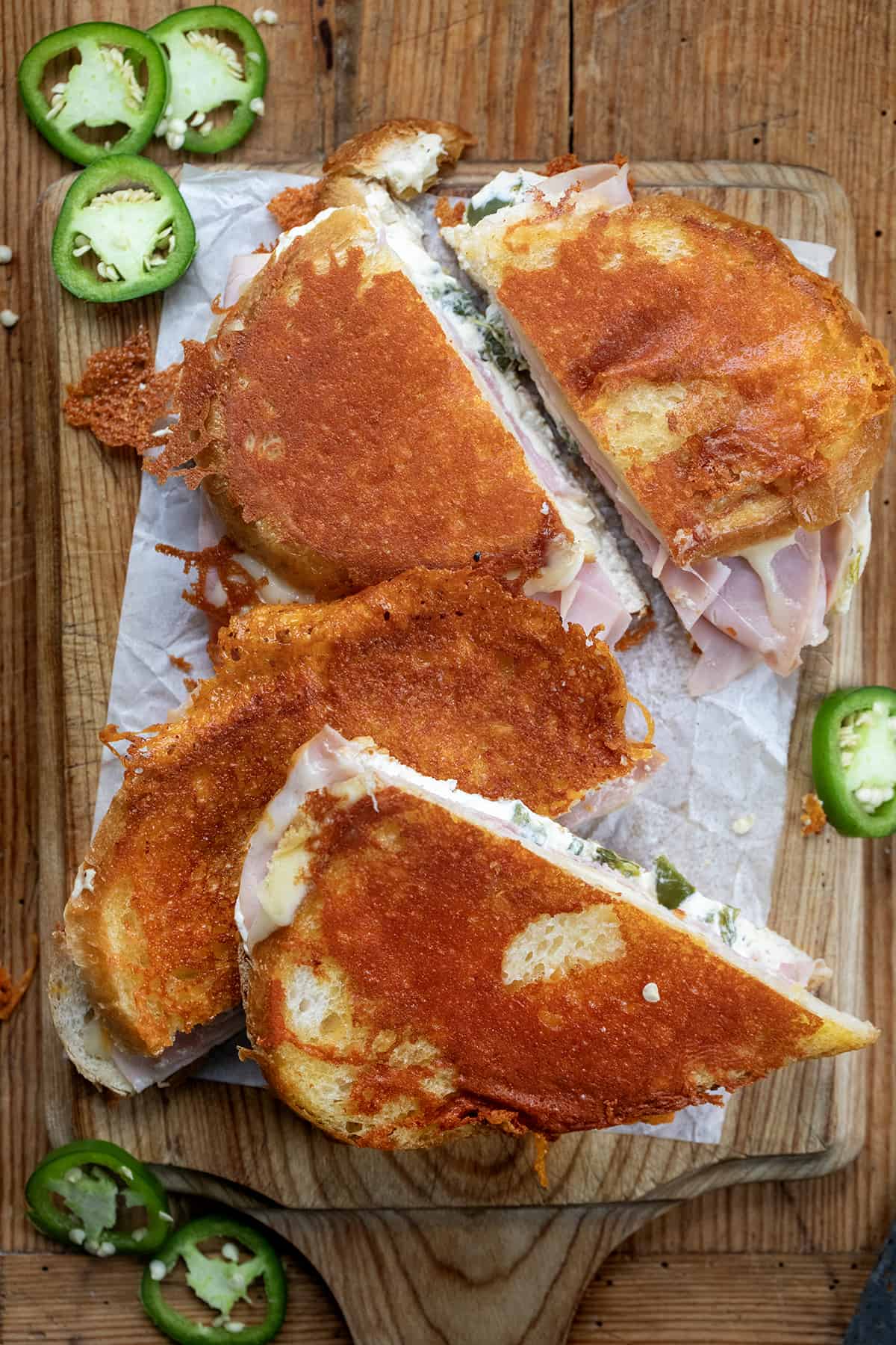Cut up Jalapeno Ham Grilled Cheese on a cutting board.