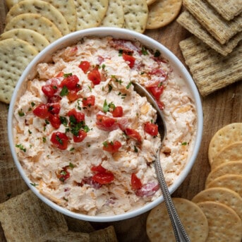 Pimento Cheese in a bowl on a cutting board with crackers from overhead.