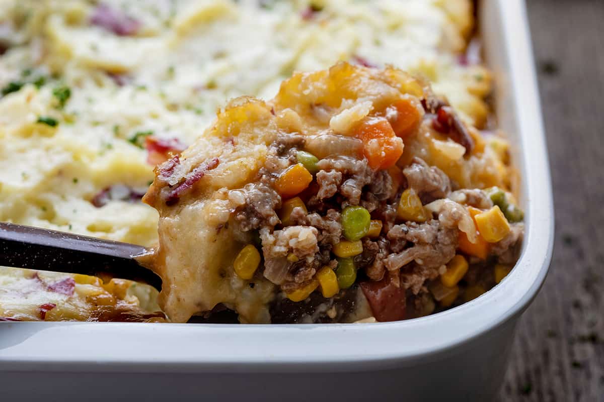 Scooping Shepherd's Pie out of the pan very close up.