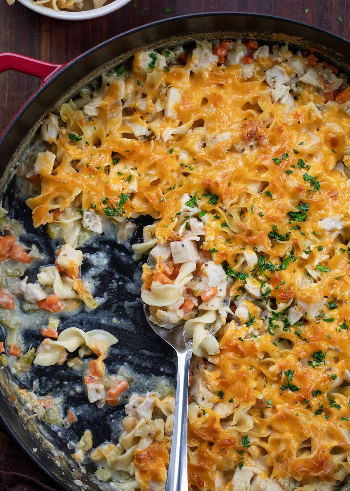 Skillet Turkey Noodle Casserole with some missing and a spoon in it.