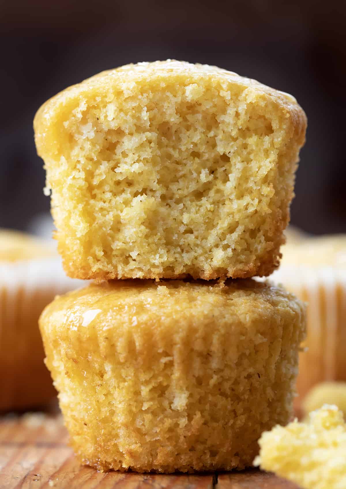 Stack of Cornbread Muffins with top muffin halved showing inside texture.