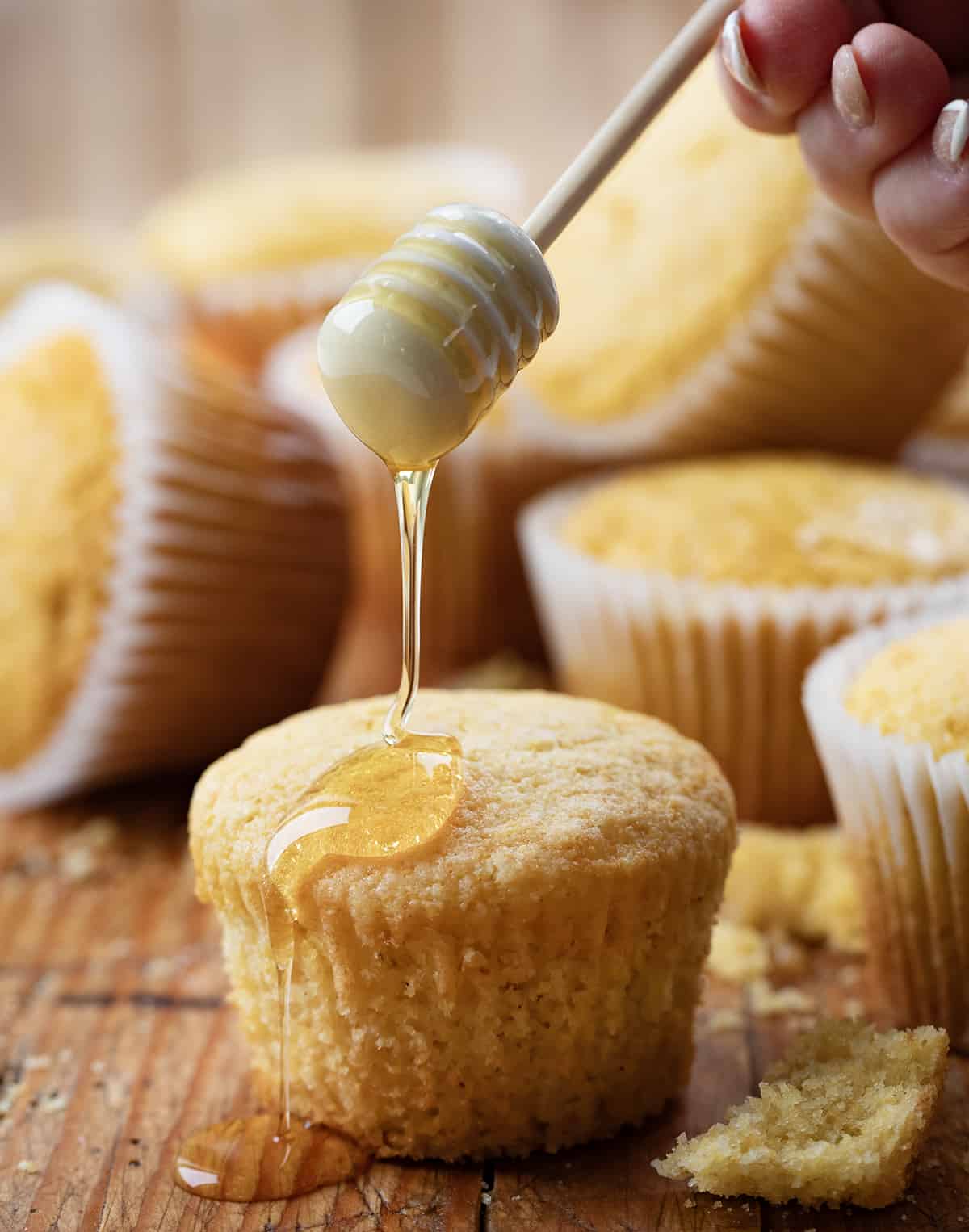 Drizzling honey over Cornbread Muffins.
